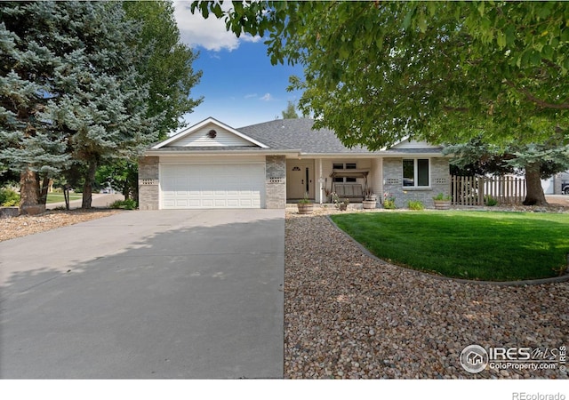 ranch-style home featuring a garage, covered porch, fence, driveway, and a front yard