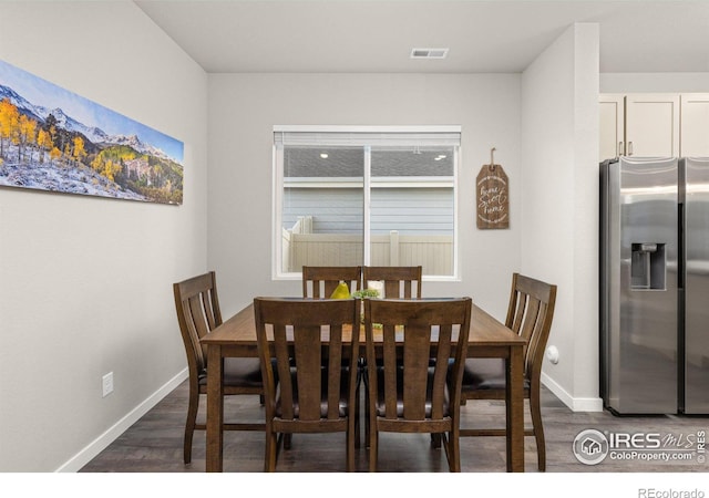 dining space with dark wood-style floors and baseboards