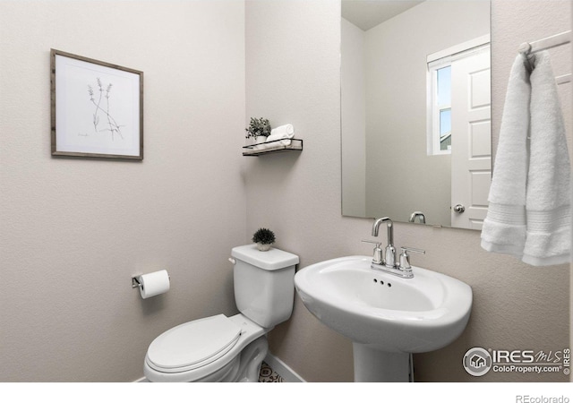 bathroom featuring toilet and a sink