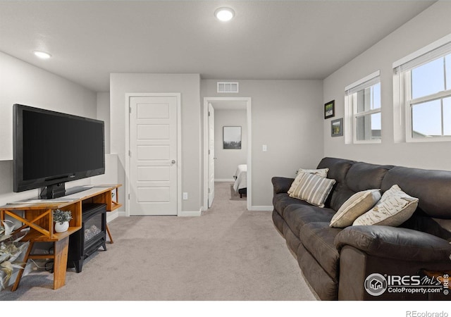 living room with recessed lighting, baseboards, visible vents, and light colored carpet