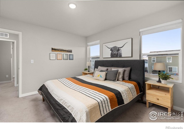 carpeted bedroom with visible vents and baseboards