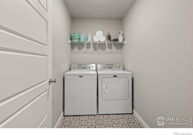 washroom with washer and dryer, laundry area, and baseboards