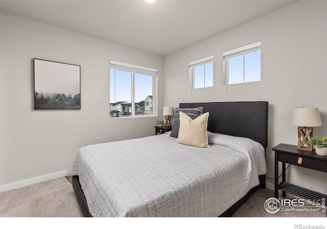 carpeted bedroom featuring baseboards