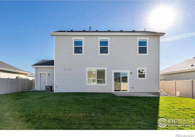 back of house featuring a yard, a fenced backyard, a patio area, and cooling unit