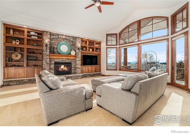 carpeted living area with baseboards, ceiling fan, built in shelves, high vaulted ceiling, and a fireplace