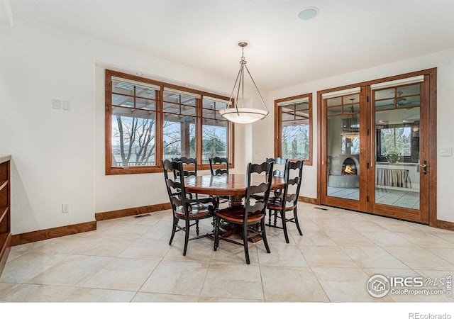 dining room featuring visible vents and baseboards