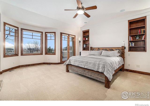 bedroom with access to outside, multiple windows, carpet, and baseboards