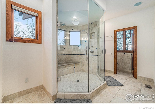 bathroom with visible vents and a shower stall