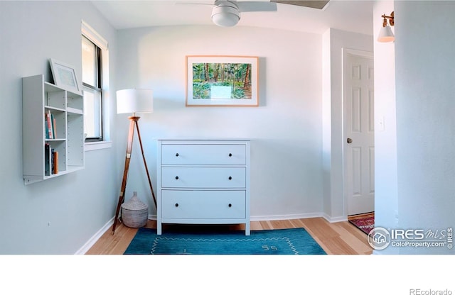 interior space featuring baseboards and wood finished floors