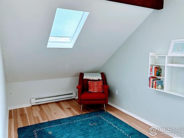 living area featuring lofted ceiling with skylight, wood finished floors, baseboards, and a baseboard radiator