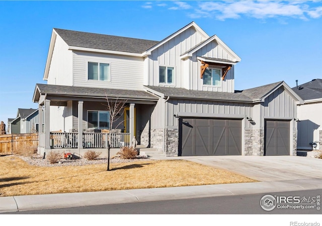 modern inspired farmhouse with driveway, a porch, board and batten siding, and stone siding