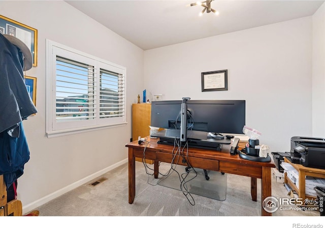 carpeted home office featuring visible vents and baseboards