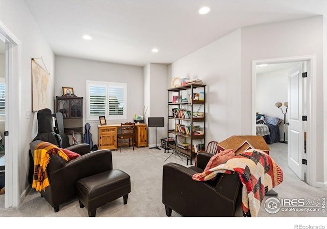 living room featuring recessed lighting, light colored carpet, and baseboards