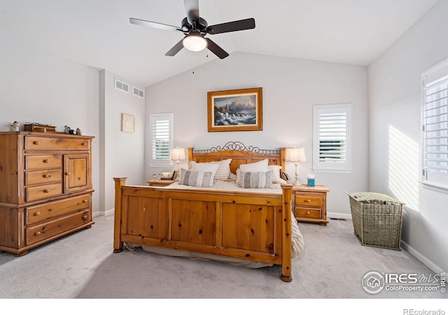 bedroom featuring light carpet, baseboards, visible vents, and lofted ceiling