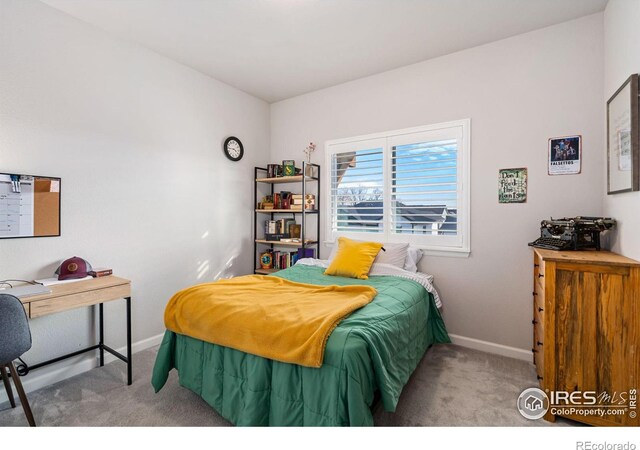 carpeted bedroom with baseboards