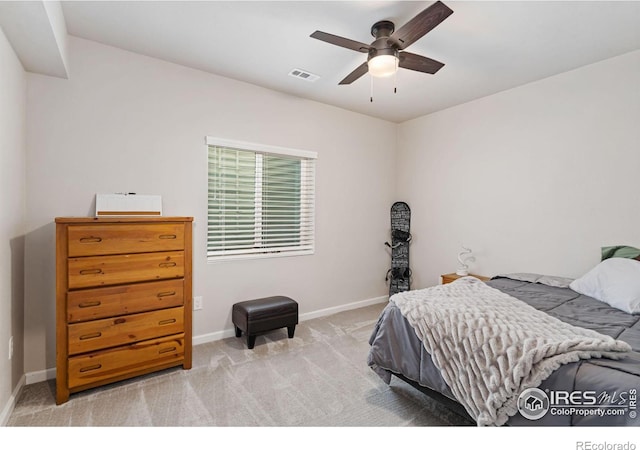 bedroom featuring light carpet, a ceiling fan, visible vents, and baseboards