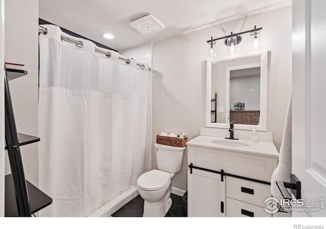 full bath featuring a shower with curtain, vanity, toilet, and tile patterned floors