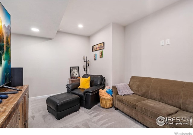 carpeted living area with baseboards and recessed lighting