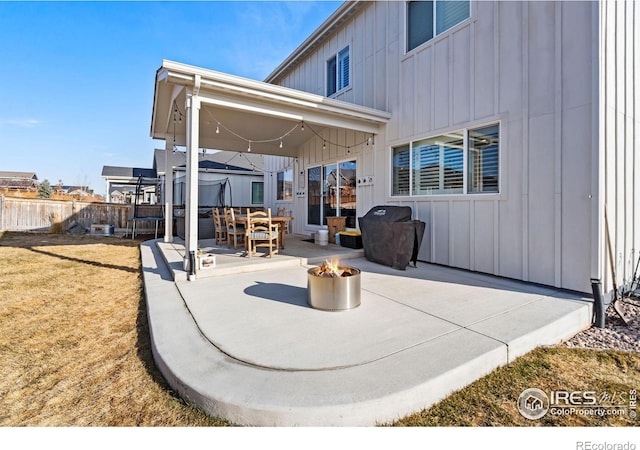 view of patio featuring an outdoor fire pit and fence