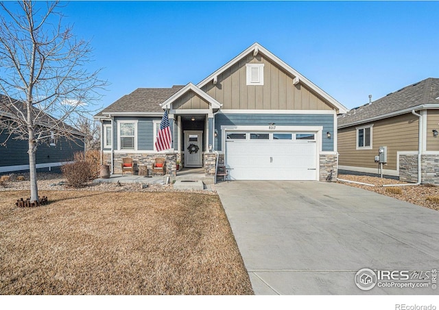 craftsman-style home featuring a garage, stone siding, board and batten siding, and concrete driveway