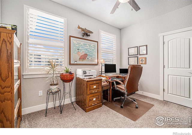 home office with carpet floors, baseboards, and a ceiling fan