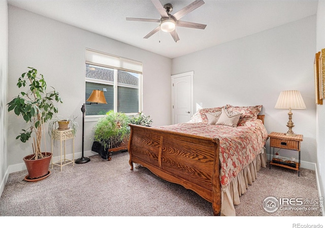 carpeted bedroom with ceiling fan and baseboards