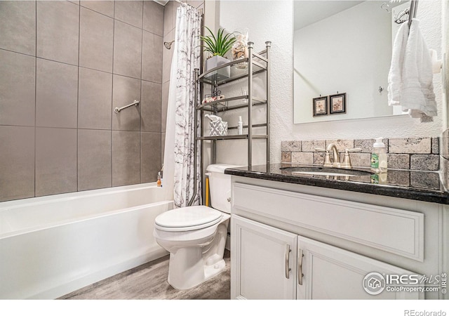 bathroom featuring vanity, wood finished floors, shower / bath combination with curtain, and toilet