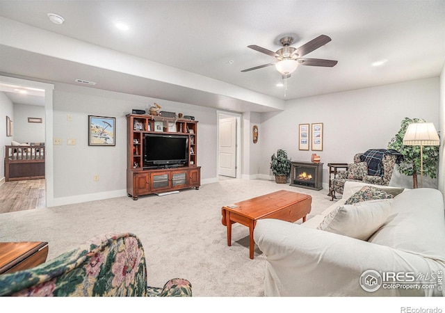 carpeted living room with a ceiling fan, recessed lighting, and baseboards