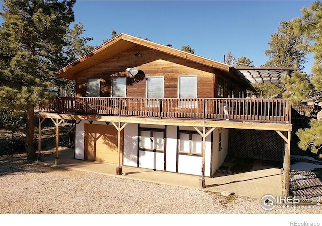 rear view of house featuring a deck