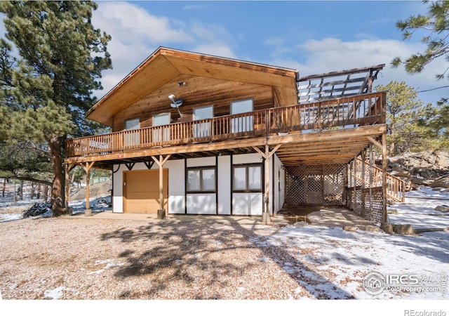 snow covered property with a deck