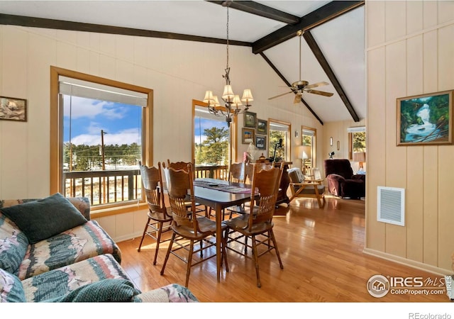 dining area with light wood-style floors, visible vents, vaulted ceiling with beams, and ceiling fan with notable chandelier