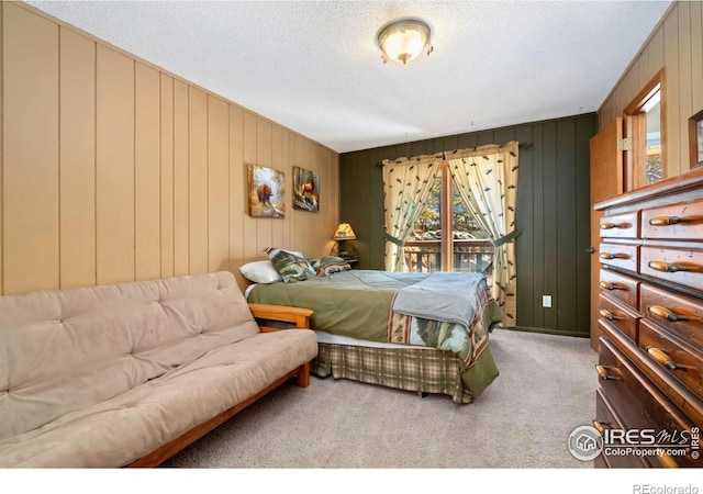 bedroom featuring carpet floors and a textured ceiling
