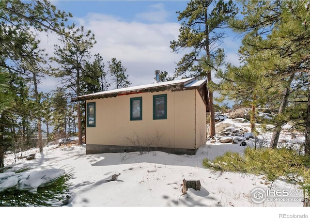 snow covered property featuring crawl space