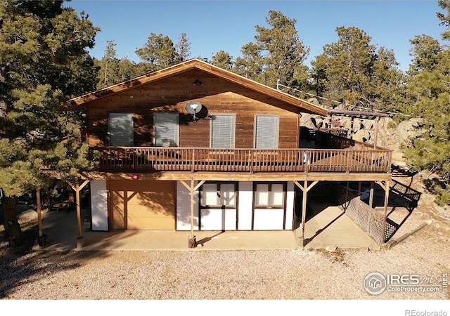 chalet / cabin with a garage and a wooden deck