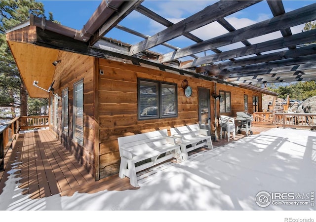deck with grilling area and a pergola