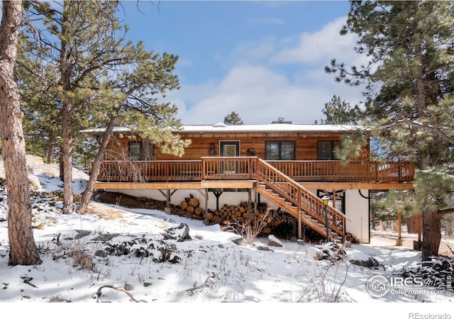 view of front of property with a deck and stairway