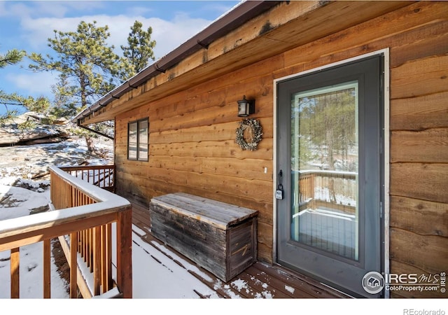 view of snow covered property entrance