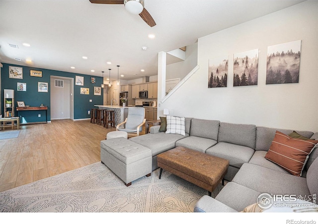 living area with ceiling fan, recessed lighting, visible vents, baseboards, and light wood finished floors