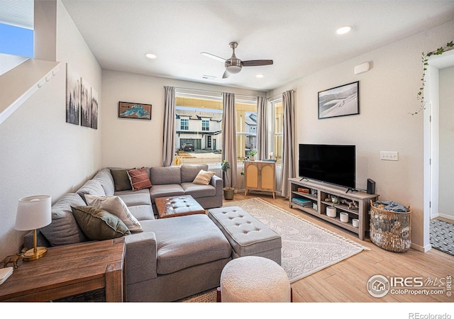 living area with ceiling fan, baseboards, wood finished floors, and recessed lighting