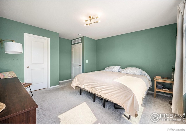 carpeted bedroom with visible vents and baseboards