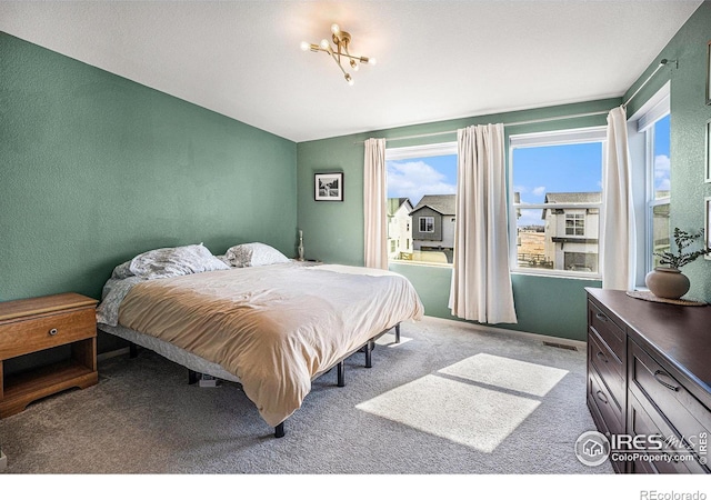 bedroom with visible vents and carpet flooring