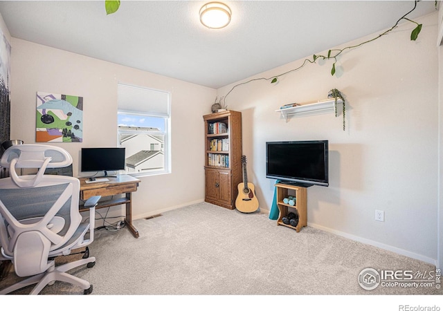 carpeted home office with visible vents and baseboards