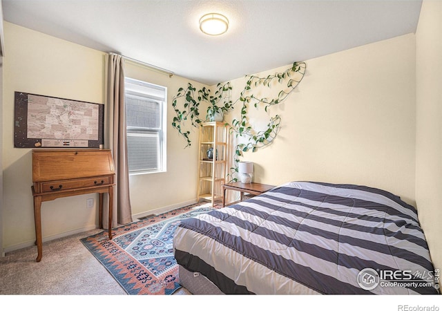 carpeted bedroom featuring baseboards