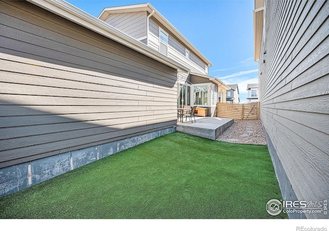 view of yard with fence and a patio