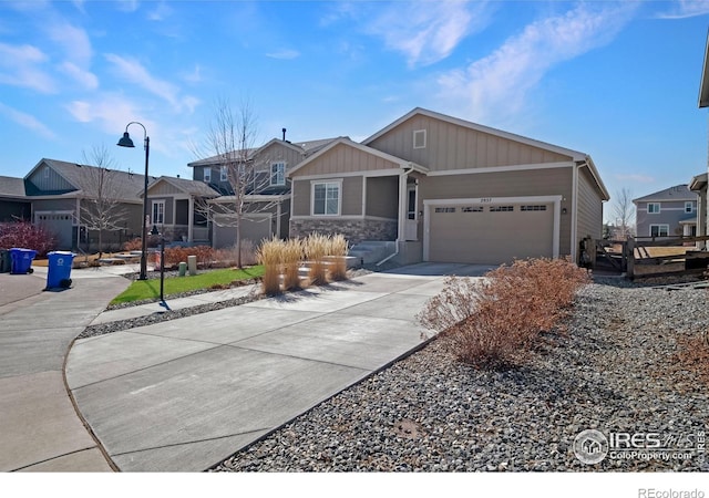 view of front facade featuring a garage, concrete driveway, fence, and a residential view