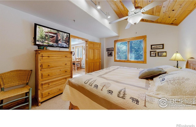 bedroom featuring lofted ceiling, ceiling fan, rail lighting, and wood ceiling