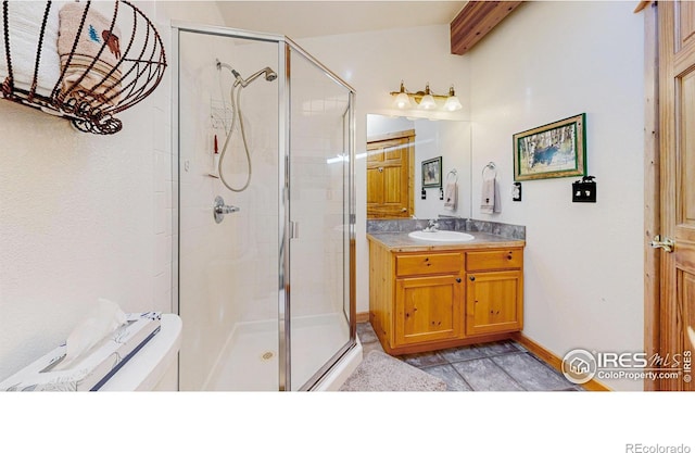 full bath with beamed ceiling, a shower stall, vanity, and baseboards