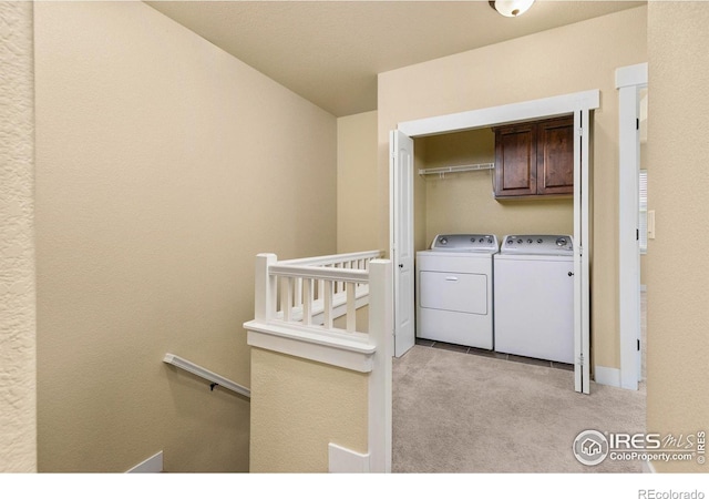 5850 Dripping Rock Ln Unit D201, Fort Collins, CO 80528 - washroom featuring light carpet, cabinet space, and washer and clothes dryer