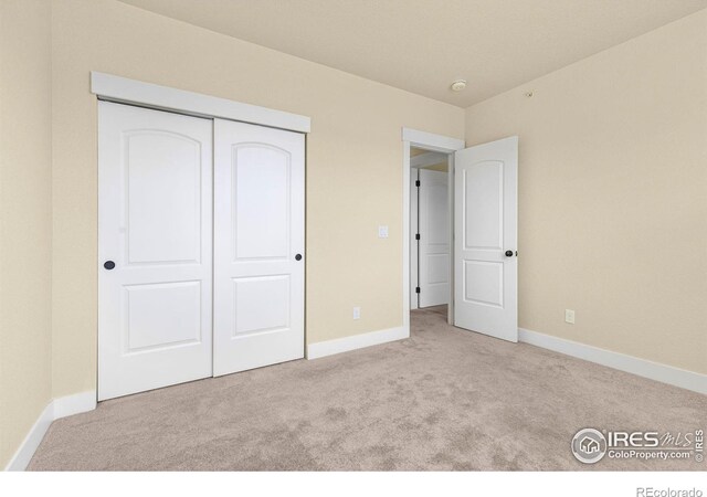 5850 Dripping Rock Ln Unit D201, Fort Collins, CO 80528 - unfurnished bedroom featuring carpet floors, baseboards, and a closet