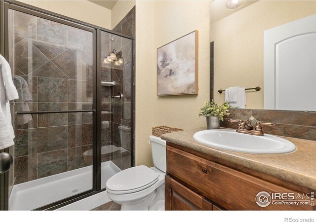 5850 Dripping Rock Ln Unit D201, Fort Collins, CO 80528 - full bath featuring toilet, a stall shower, and vanity